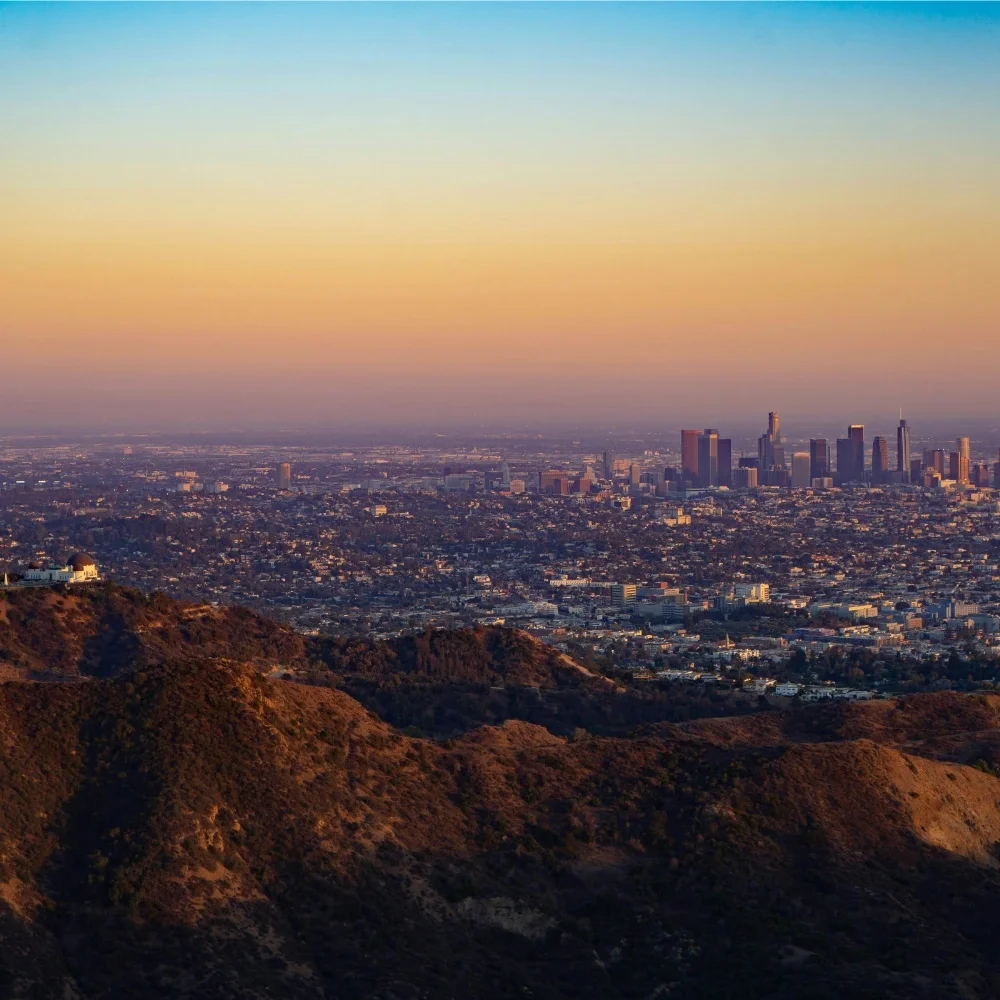 Photo of LA cityscape with downtown LA in the background and the Getty Center in the foreground
